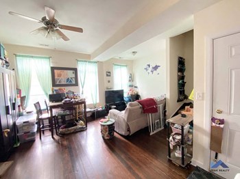 a living room filled with furniture and a ceiling fan