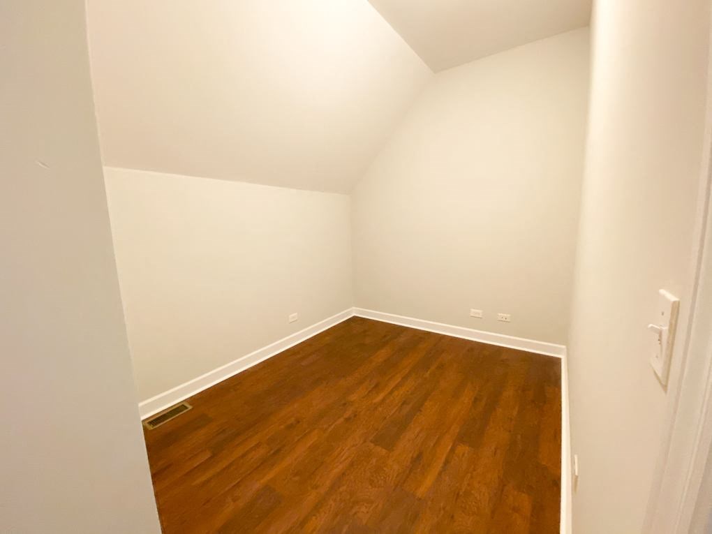 a empty room with wooden floors and white walls