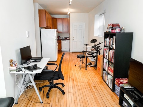 A room with a desk, chair, and bookshelf.