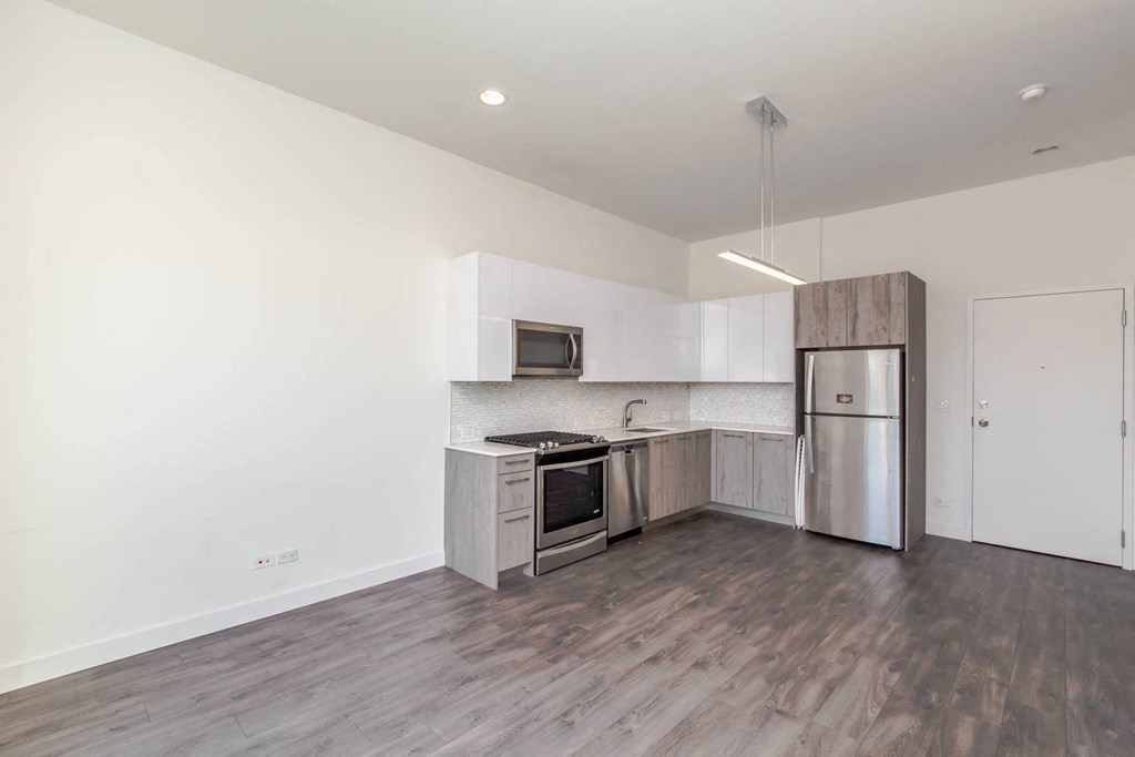 a kitchen with stainless steel appliances and white walls