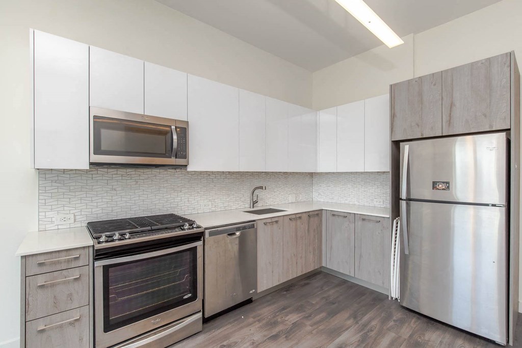 a kitchen with stainless steel appliances and white cabinets