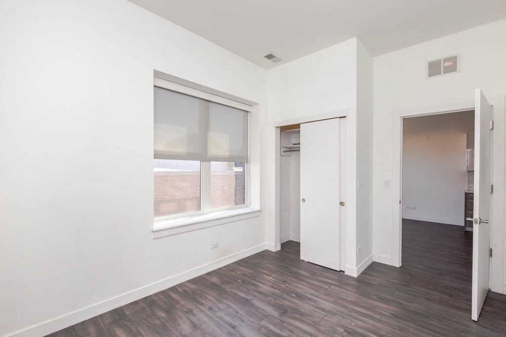 a living room with white walls and a window