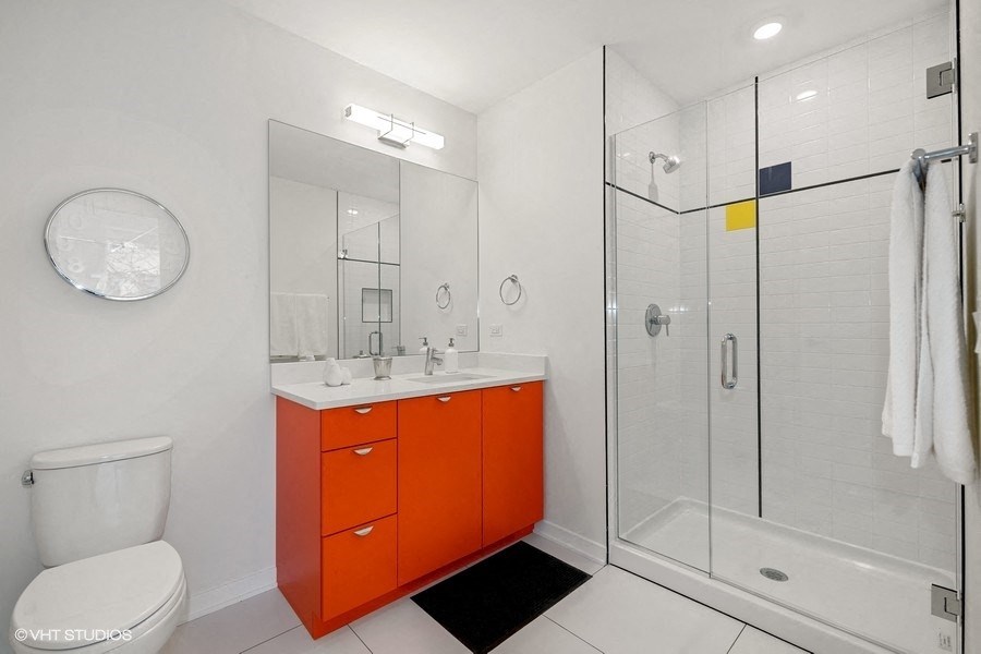 a bathroom with a red cabinet and a shower