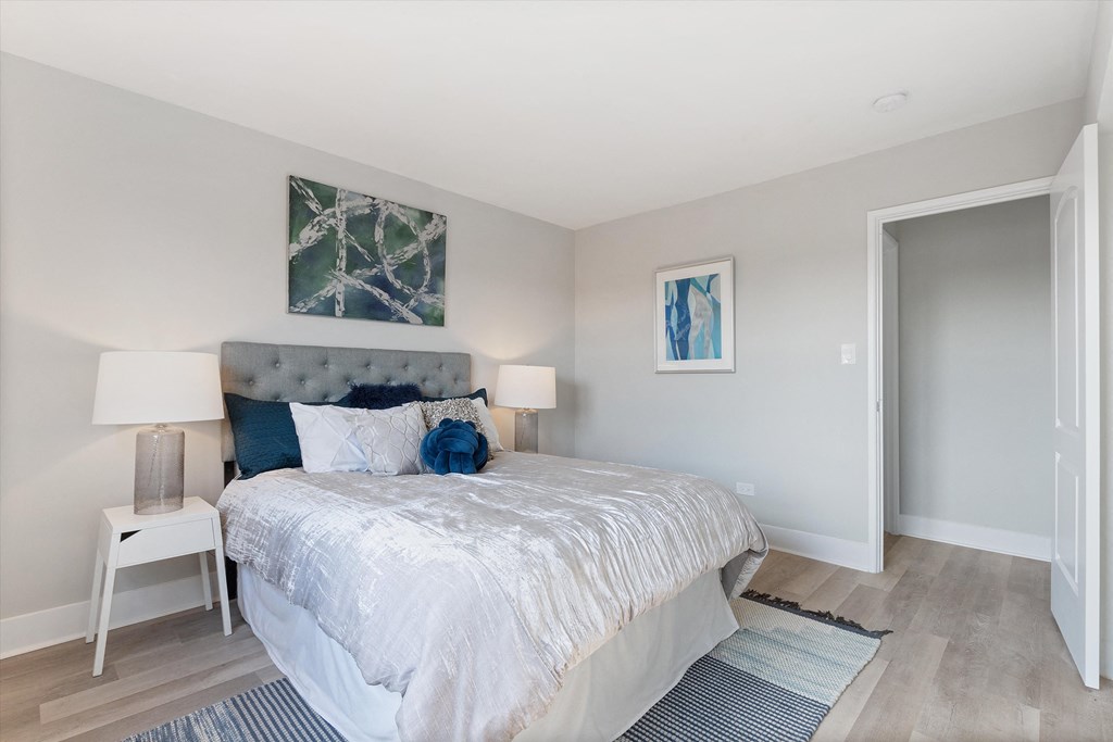 a bedroom with a bed and a door to a bathroom