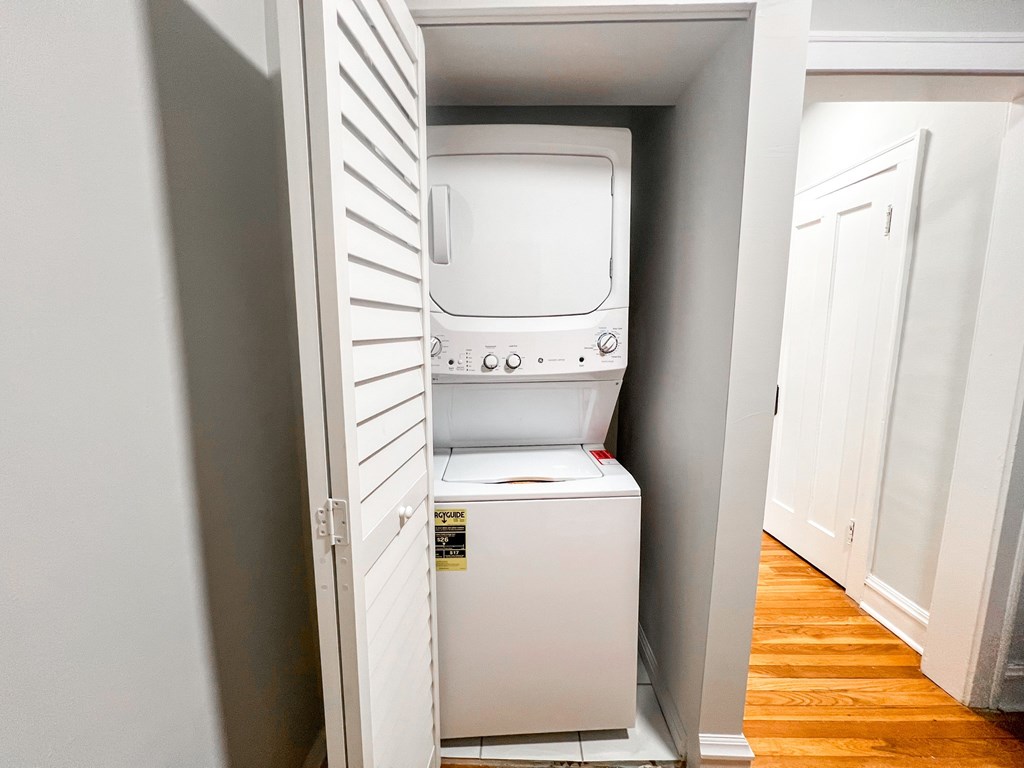 A white dishwasher is open in a kitchen.