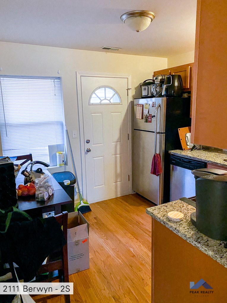 a kitchen with a refrigerator and a door