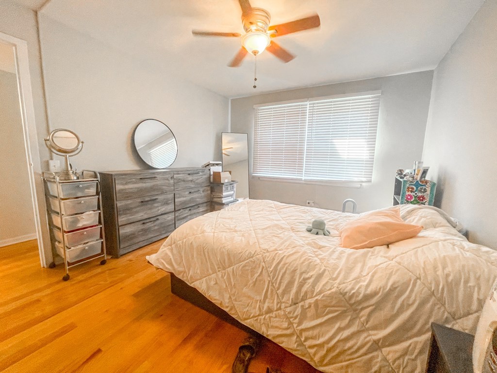 a bedroom with a bed and a ceiling fan