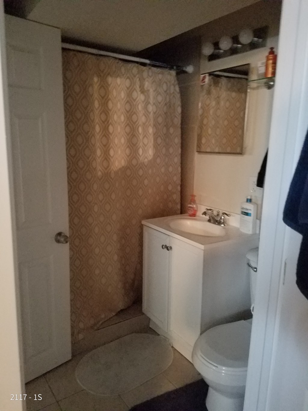 a small bathroom with a sink toilet and shower