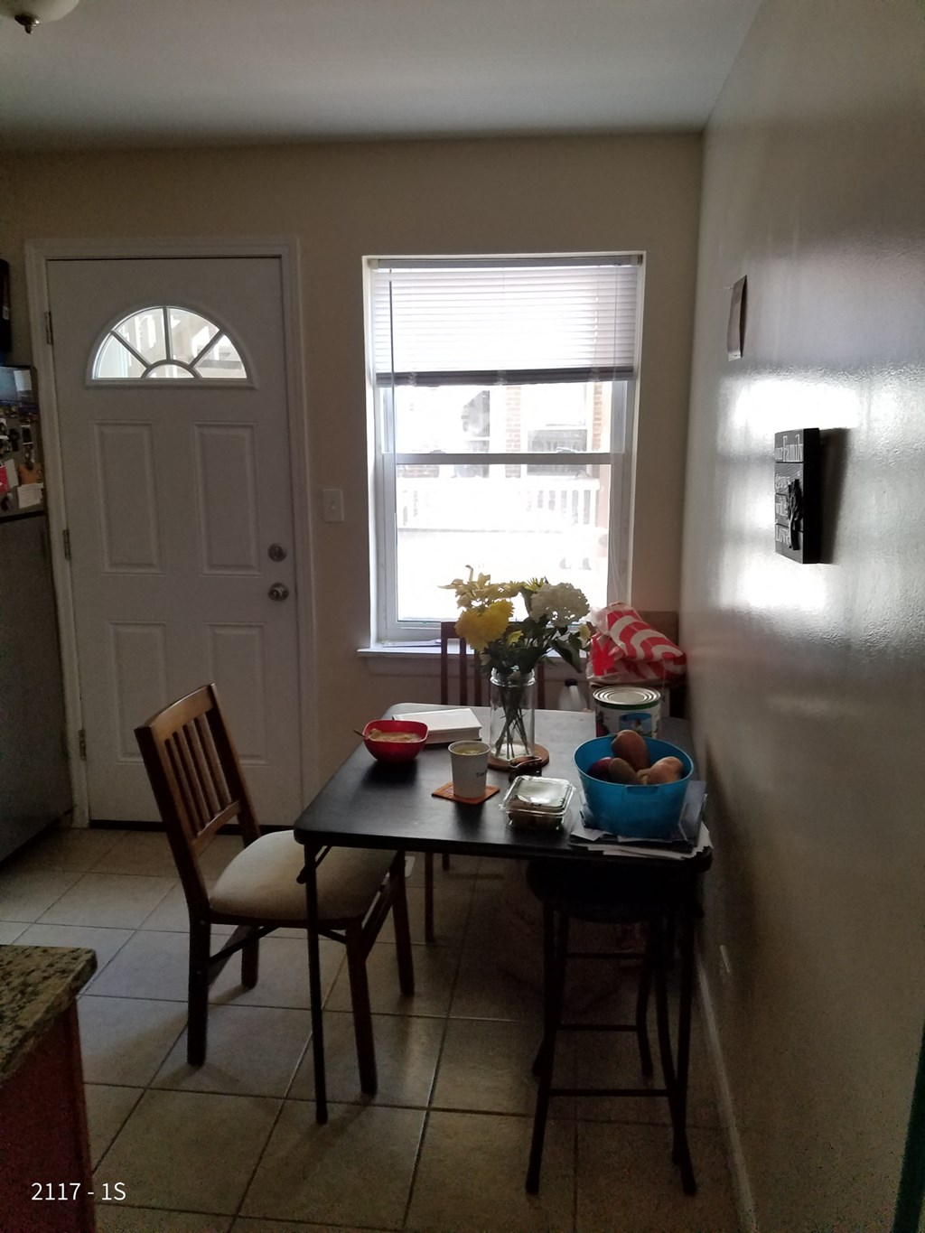 a kitchen with a table and chairs and a window