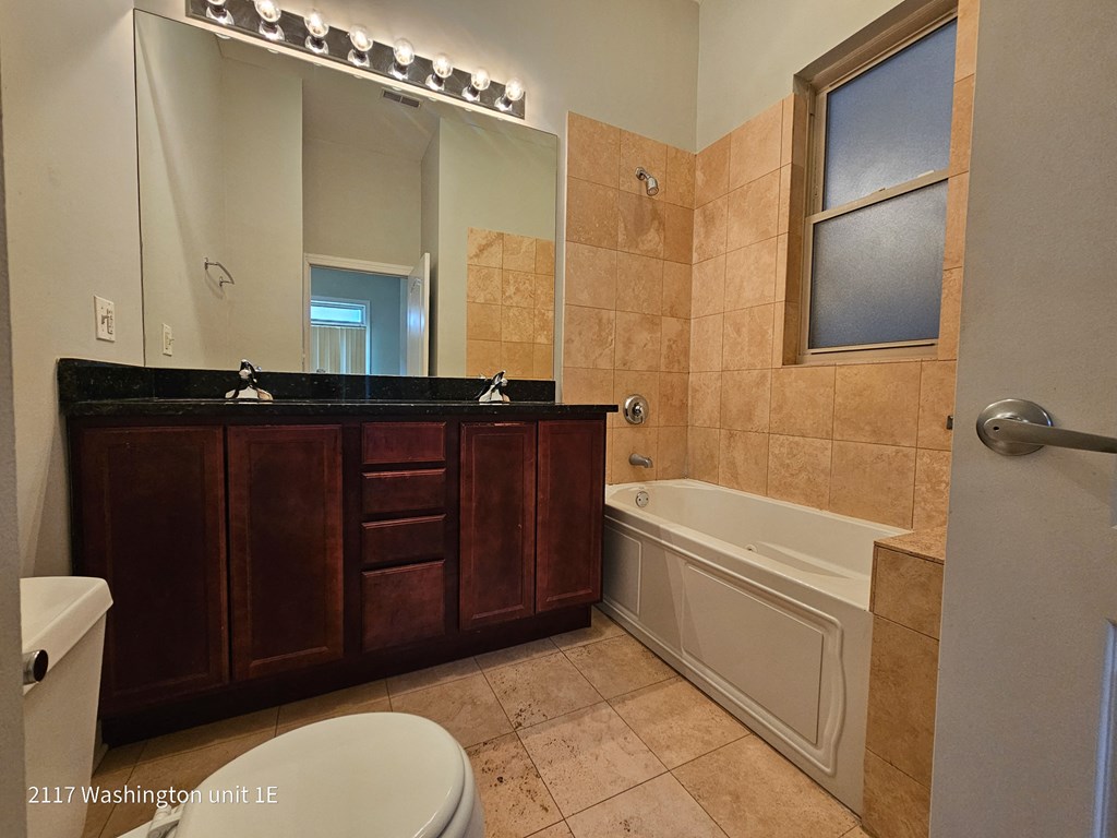 a bathroom with a sink toilet and a bath tub