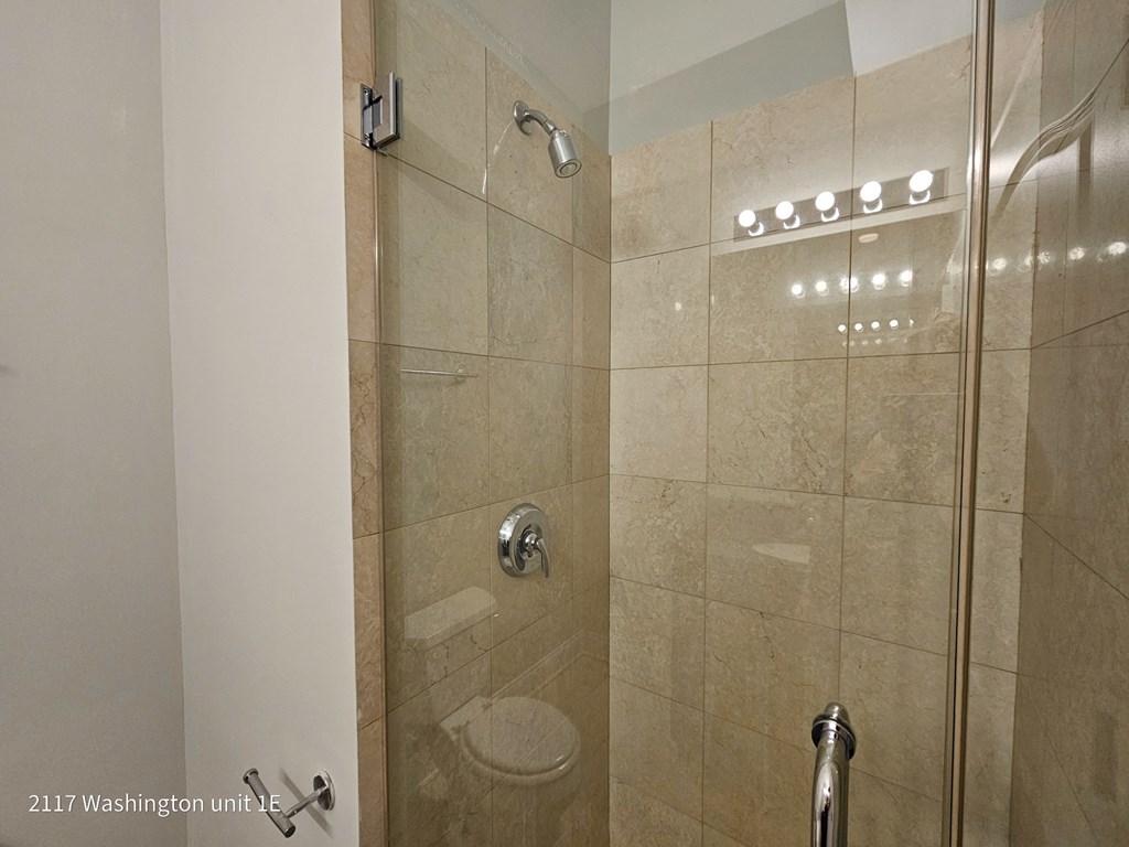 a bathroom with a shower and a toilet in it