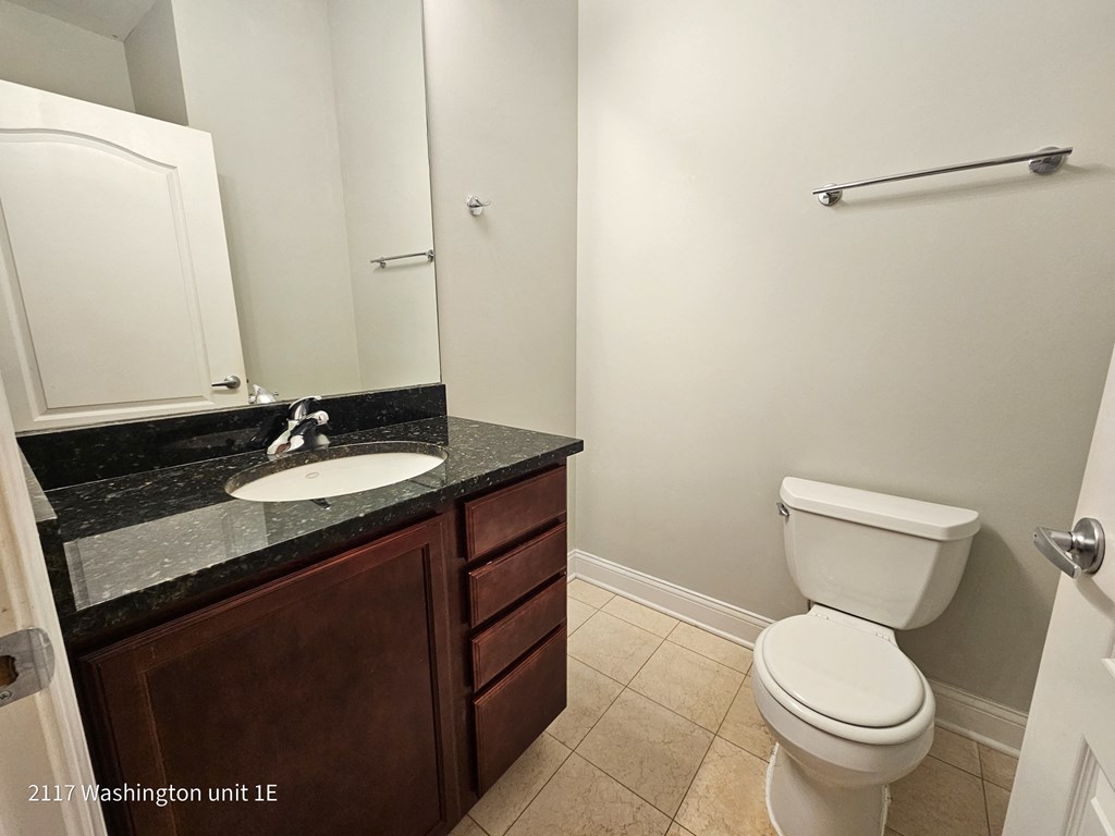 a bathroom with a toilet and a sink and a mirror