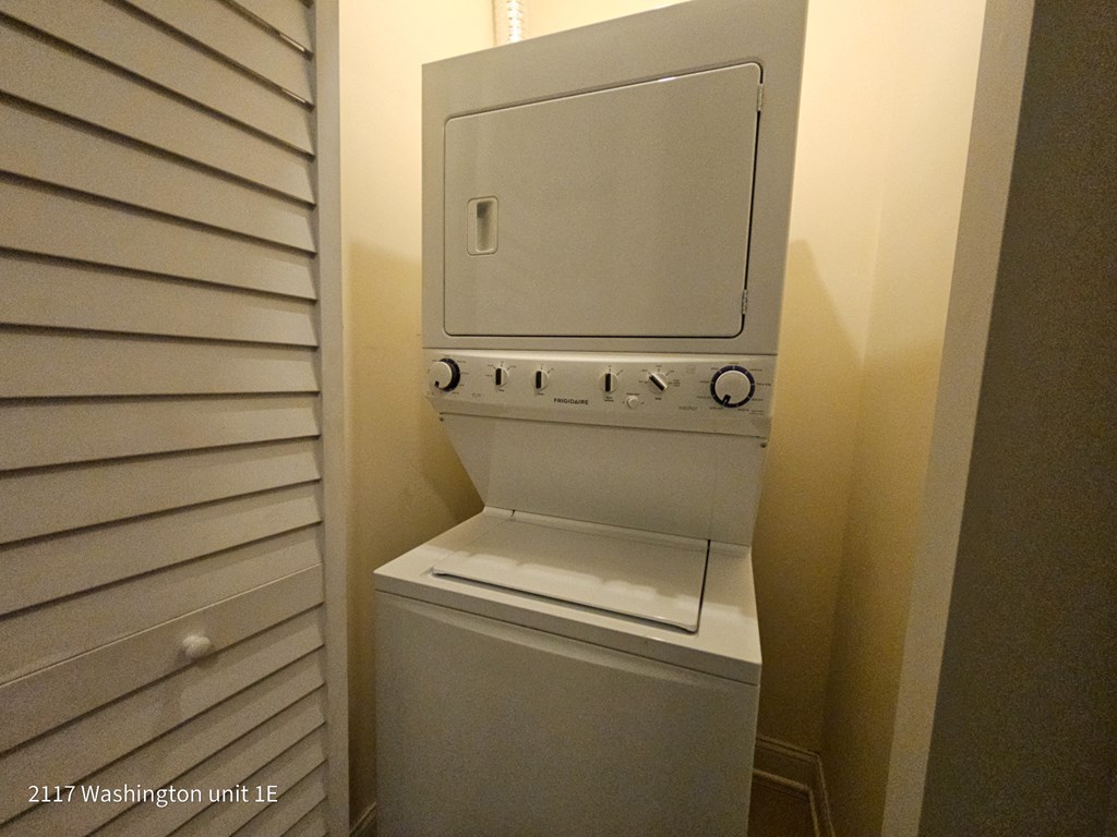 a washer and dryer in a closet in a bathroom