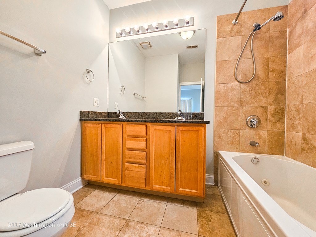 a bathroom with a sink toilet and shower and a tub