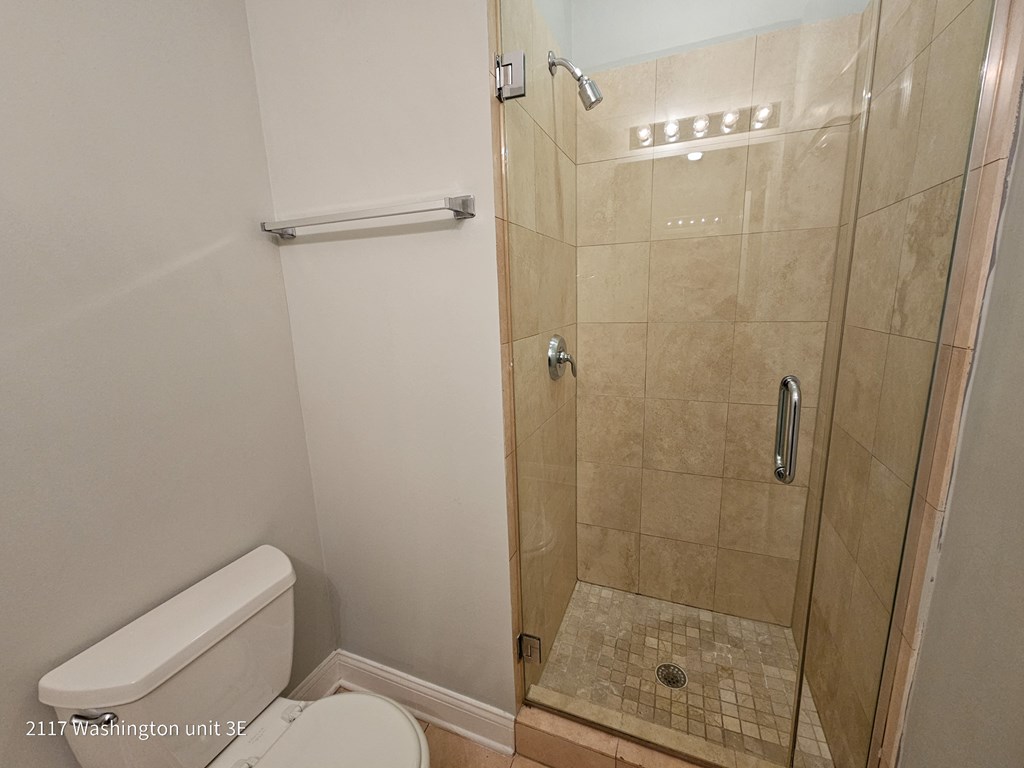 a small bathroom with a shower and a toilet