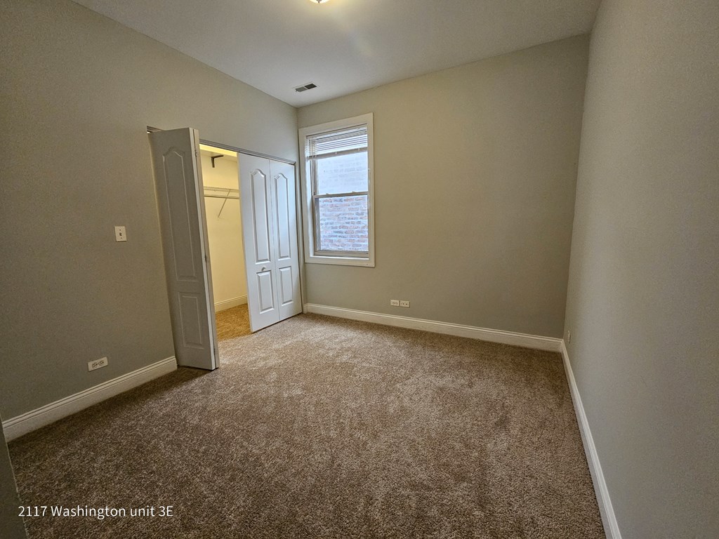 an empty room with a door and a window