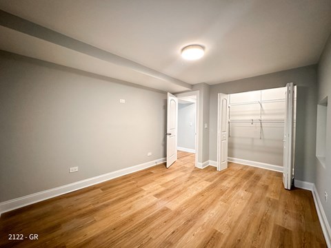 A room with wooden flooring and a white door.