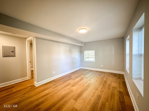A room with wooden floors and white walls.