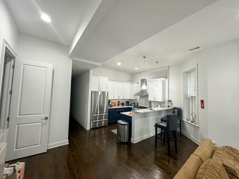 a living room with a kitchen and a couch