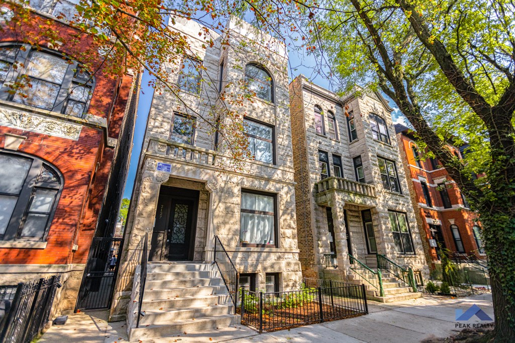 a row of town houses with trees in front of them