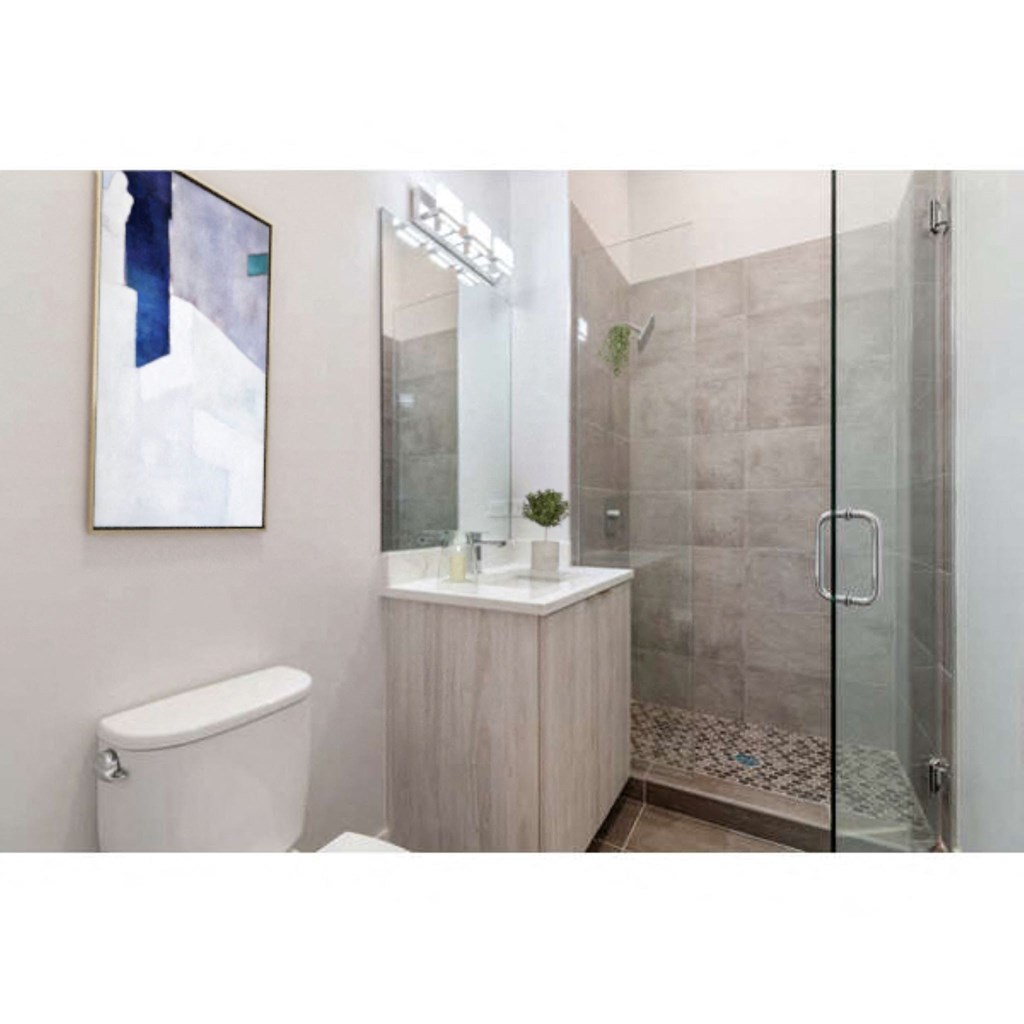 a bathroom with a toilet sink and shower stall