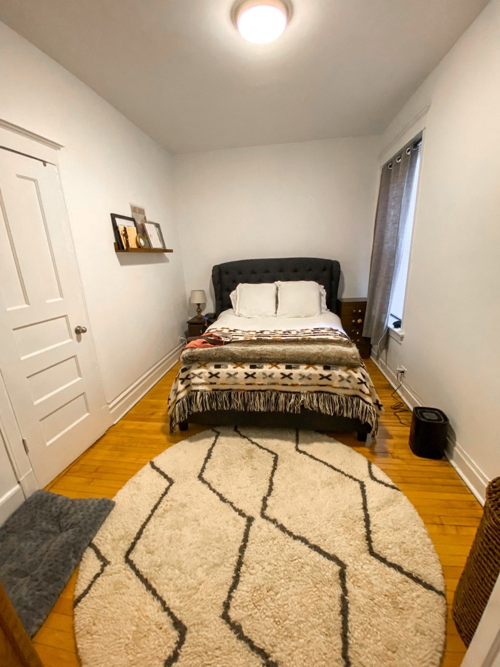 a bedroom with a bed and a rug