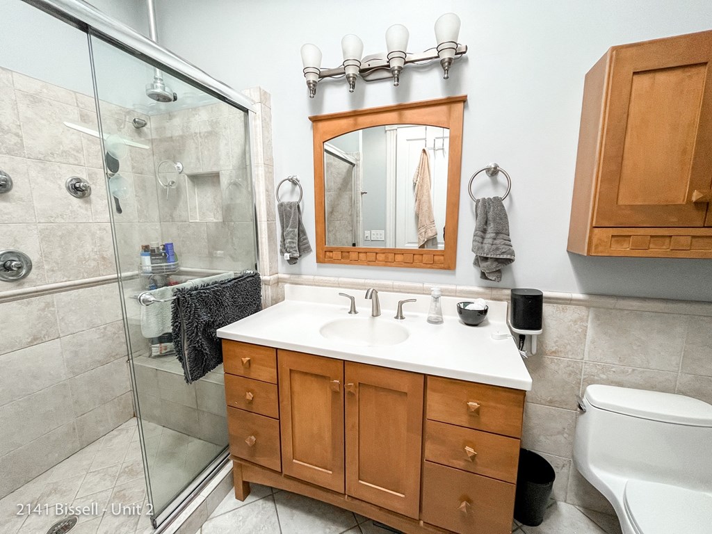 a bathroom with a shower sink toilet and mirror