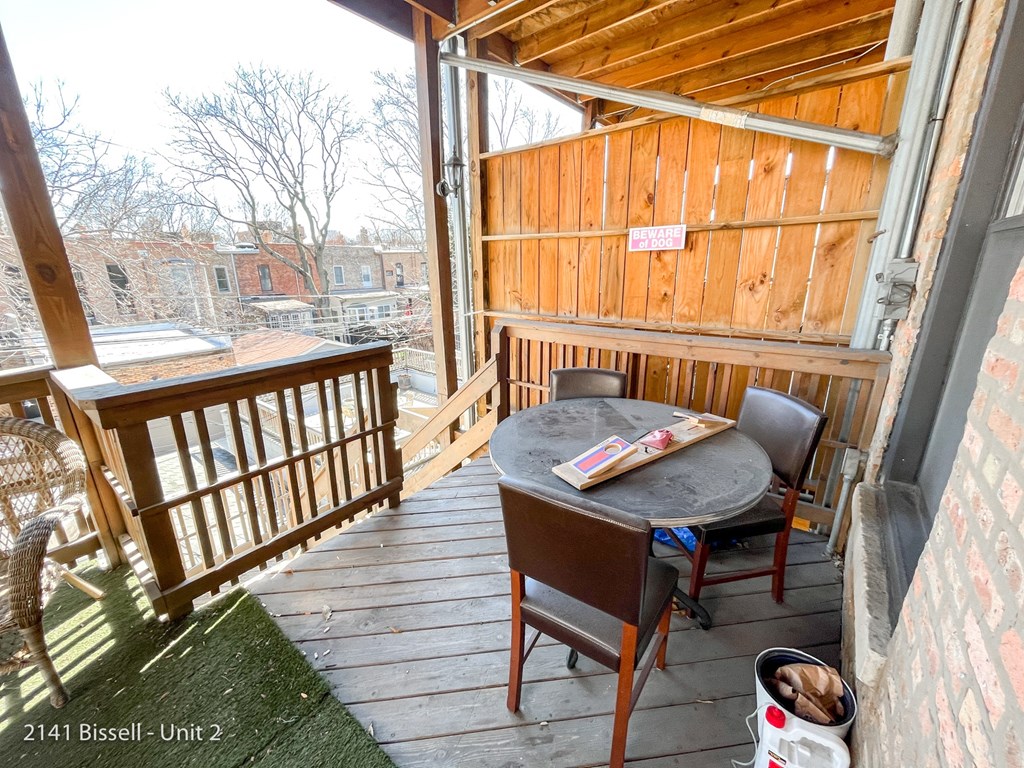 a deck with a table and chairs and a sliding glass door