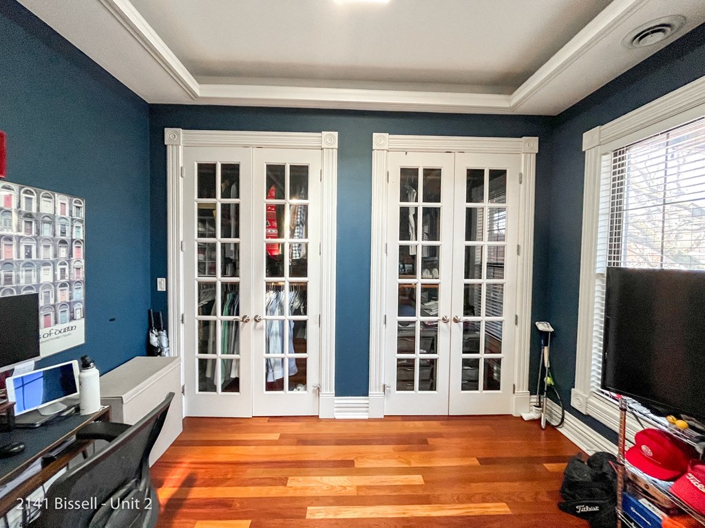 a home office with blue walls and white french doors