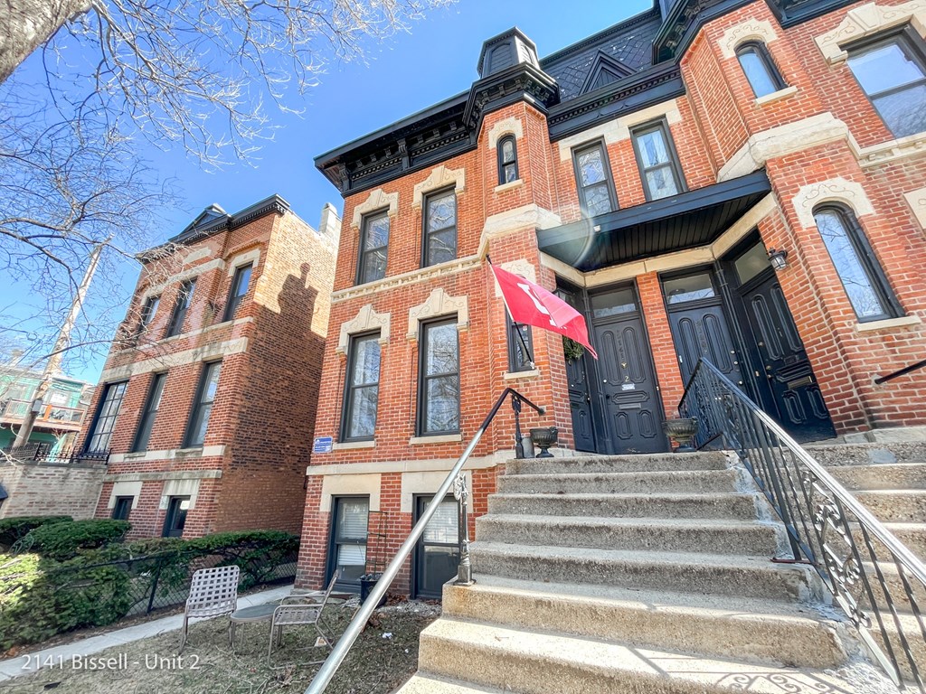 a red brick building with a chinese flag in front of it
