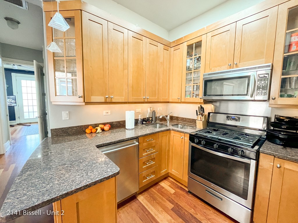 a kitchen with wood cabinets and granite counter tops