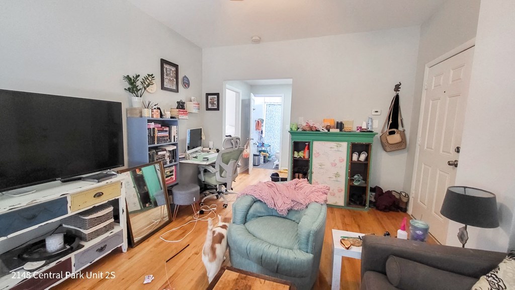 a living room filled with furniture and a tv