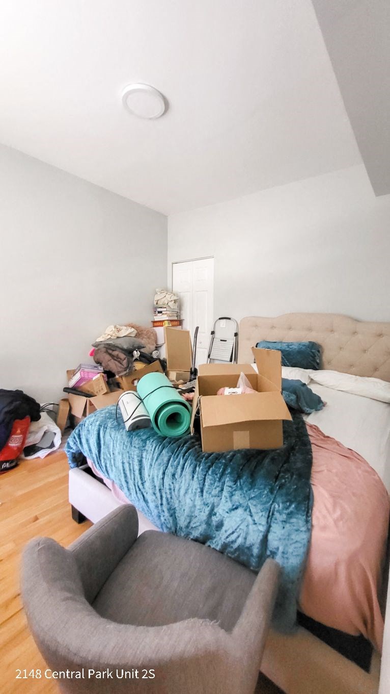 a bedroom with a bed and boxes on top of it