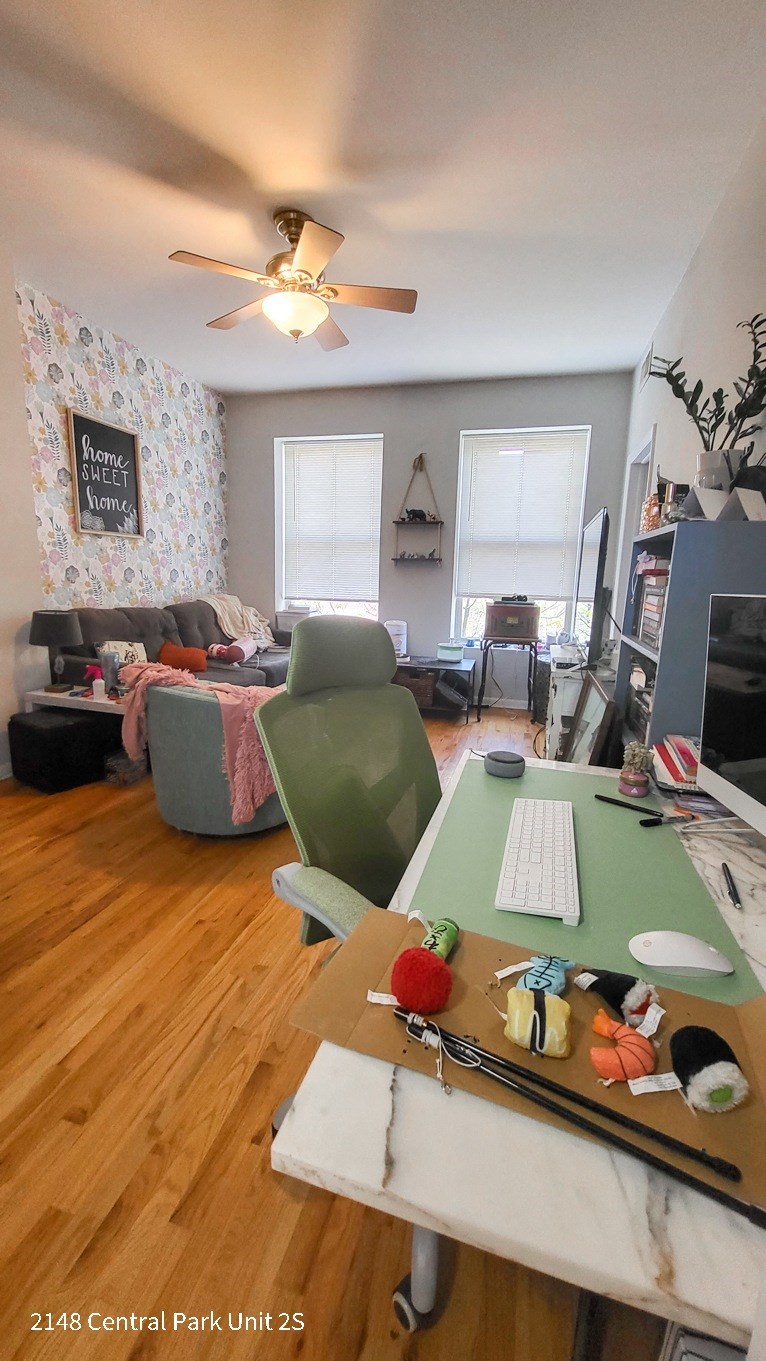 a living room with a desk and a computer