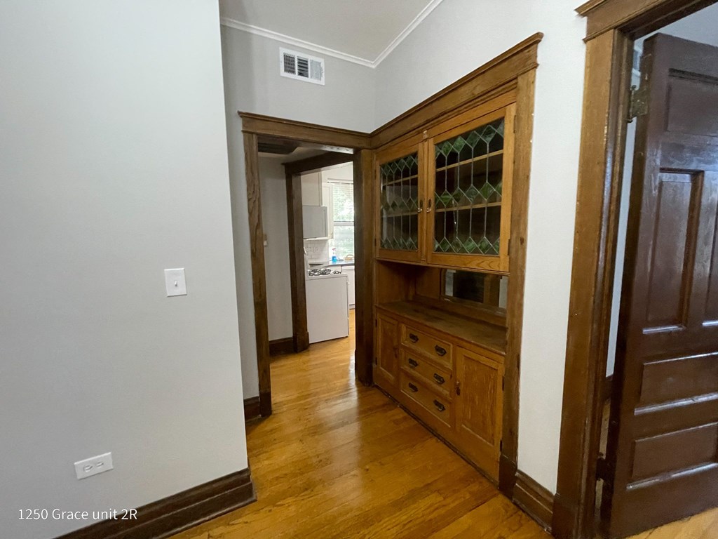 a dining room with a hutch and a door to a bathroom
