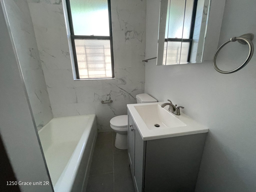 a bathroom with a sink toilet and a bath tub