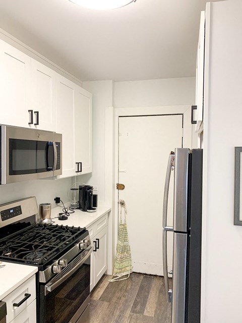 a kitchen with a stove and a refrigerator