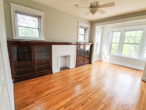 A room with wooden floors and a fireplace.
