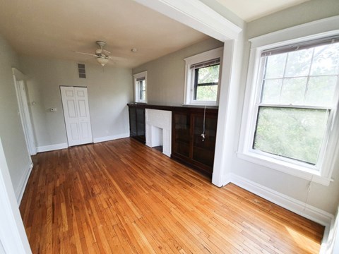 A room with wooden floors and white walls.
