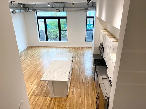 A kitchen with a table and a window.