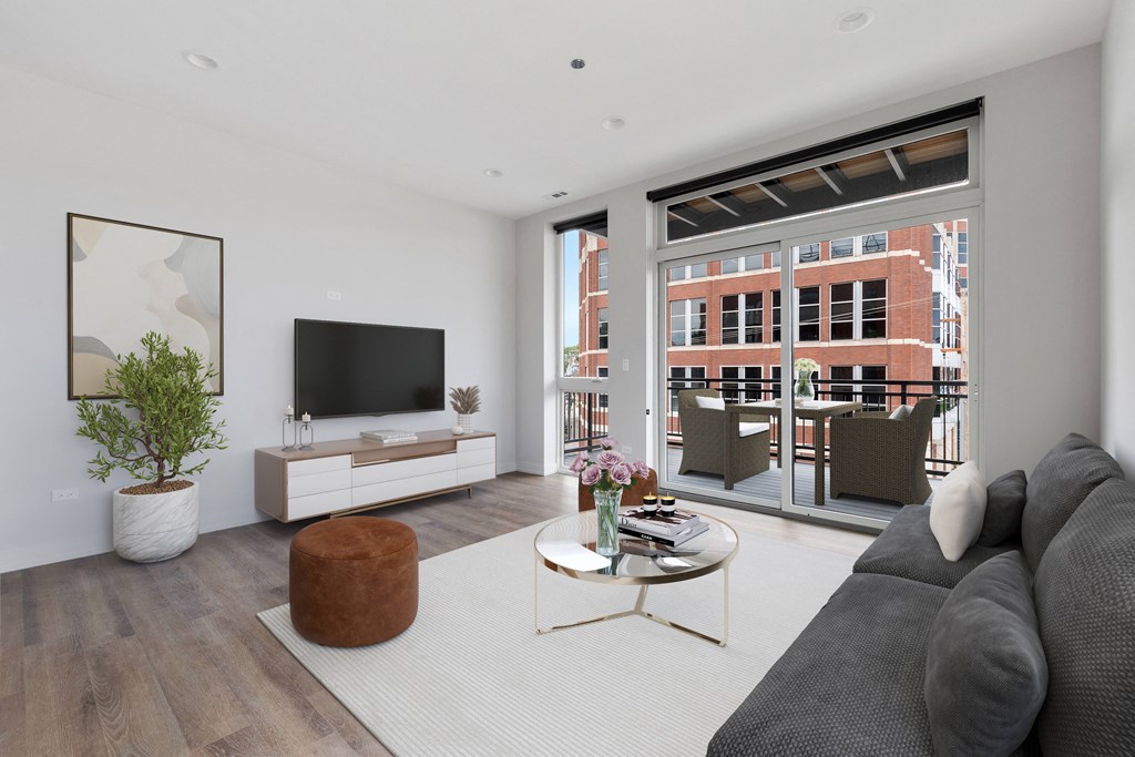 a living room with white walls and hardwood floors