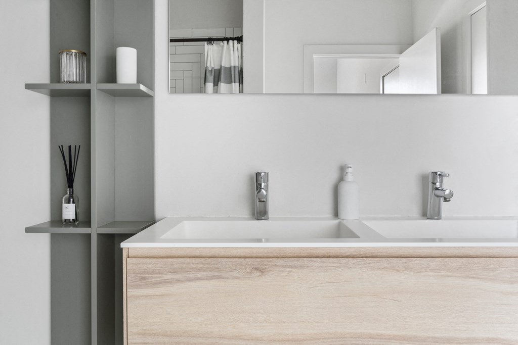 A close up of a bathroom sink with a mirror above it