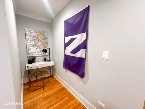 A room with a purple flag and a map on the wall.