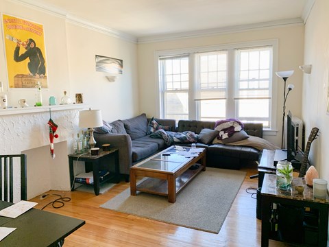 A living room with a fireplace and a couch.