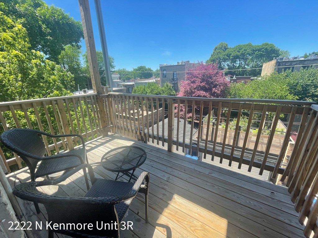 the view from the deck of a balcony with a table and chairs