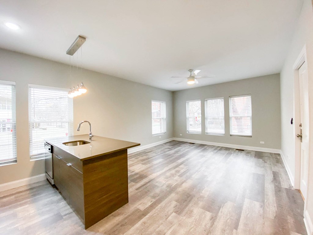 an empty living room and kitchen in a new home