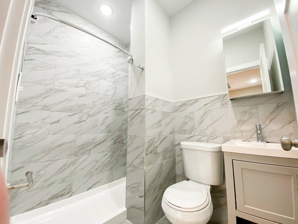 a bathroom with a toilet and a shower