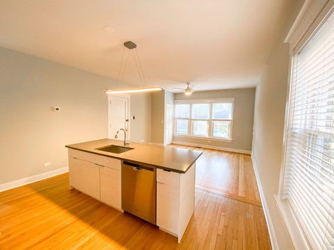 A kitchen with a sink and a window.