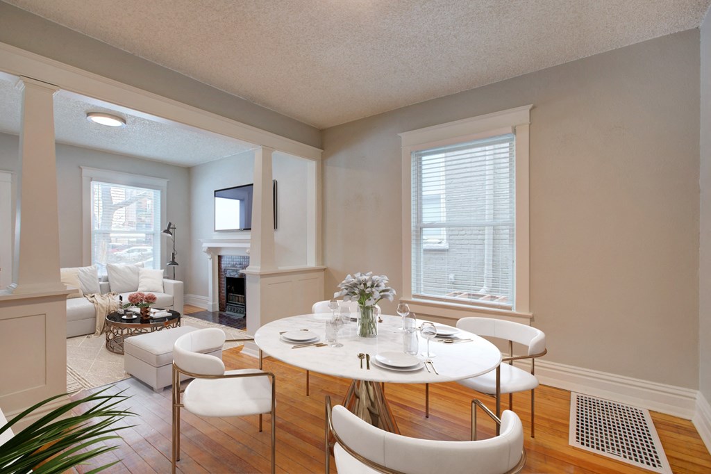 a dining room with a table and chairs and a living room