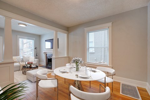 a dining room with a table and chairs and a living room